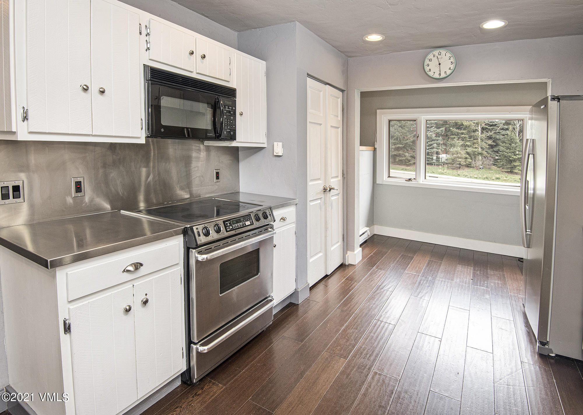 211 Nottingham Road, Unit F Avon, CO 81620 - Photo 8 of 26 a kitchen with granite countertop wooden floors appliances and sink