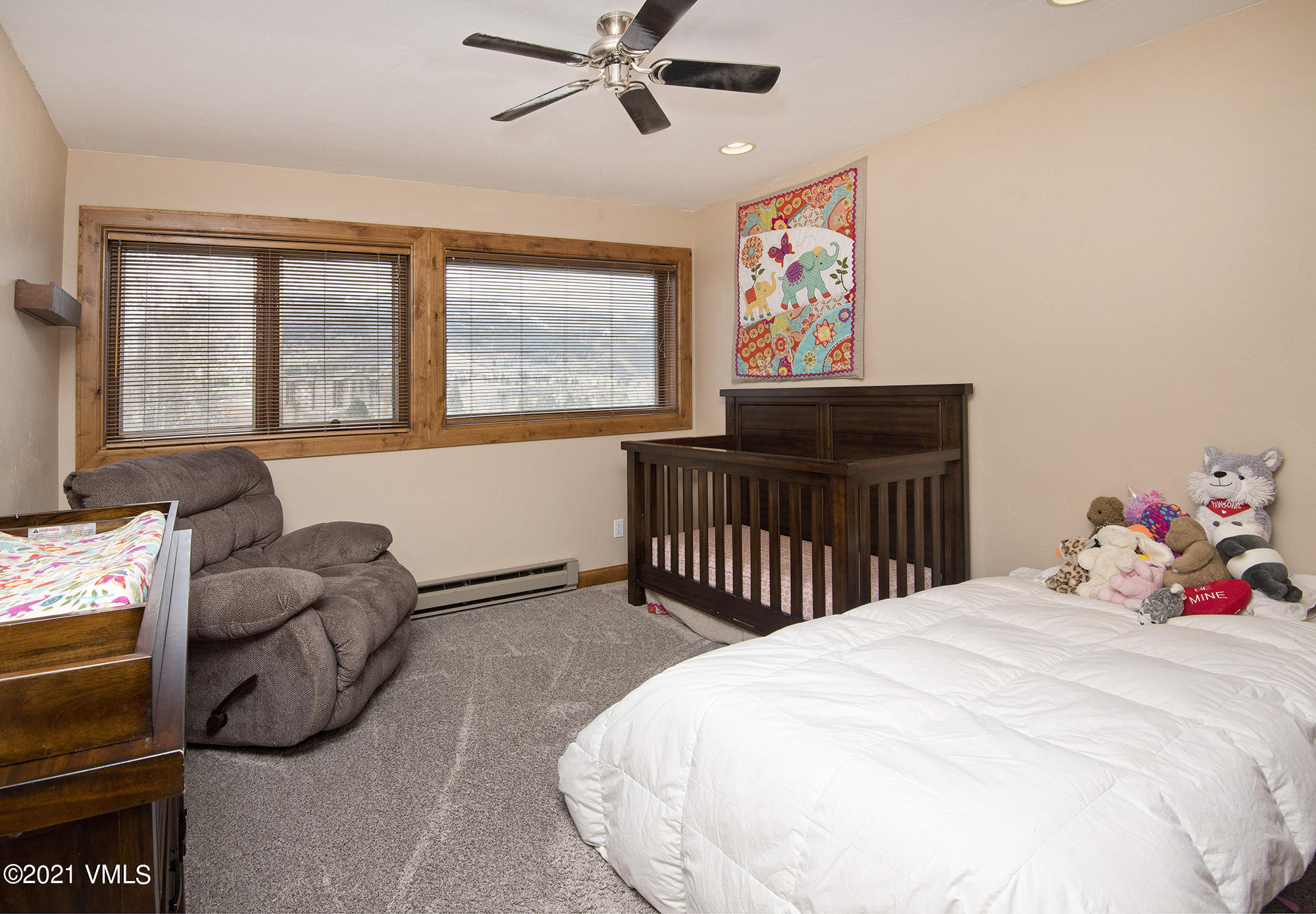 211 Nottingham Road, Unit F Avon, CO 81620 - Photo 10 of 26 a bedroom with a bed and a large window