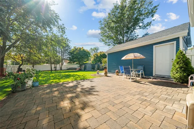 a view of a house with backyard porch and sitting area