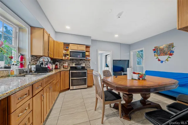 a kitchen with stainless steel appliances kitchen island granite countertop a sink and cabinets