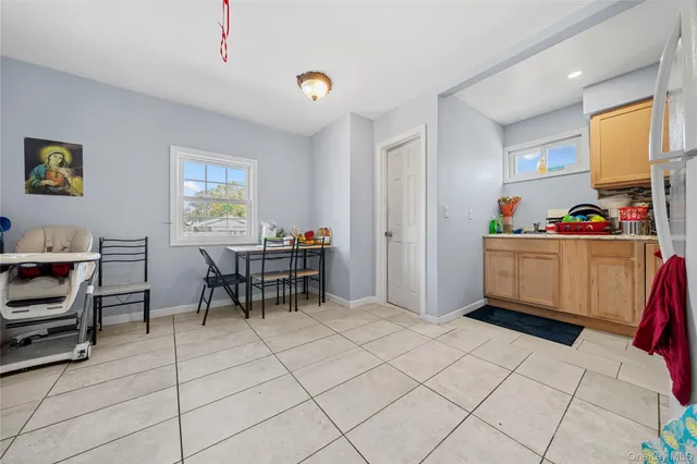 a work room with furniture a rug and a window
