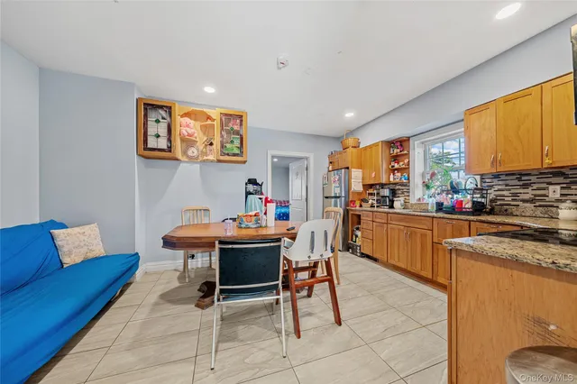 a outdoor dining space with furniture and a kitchen
