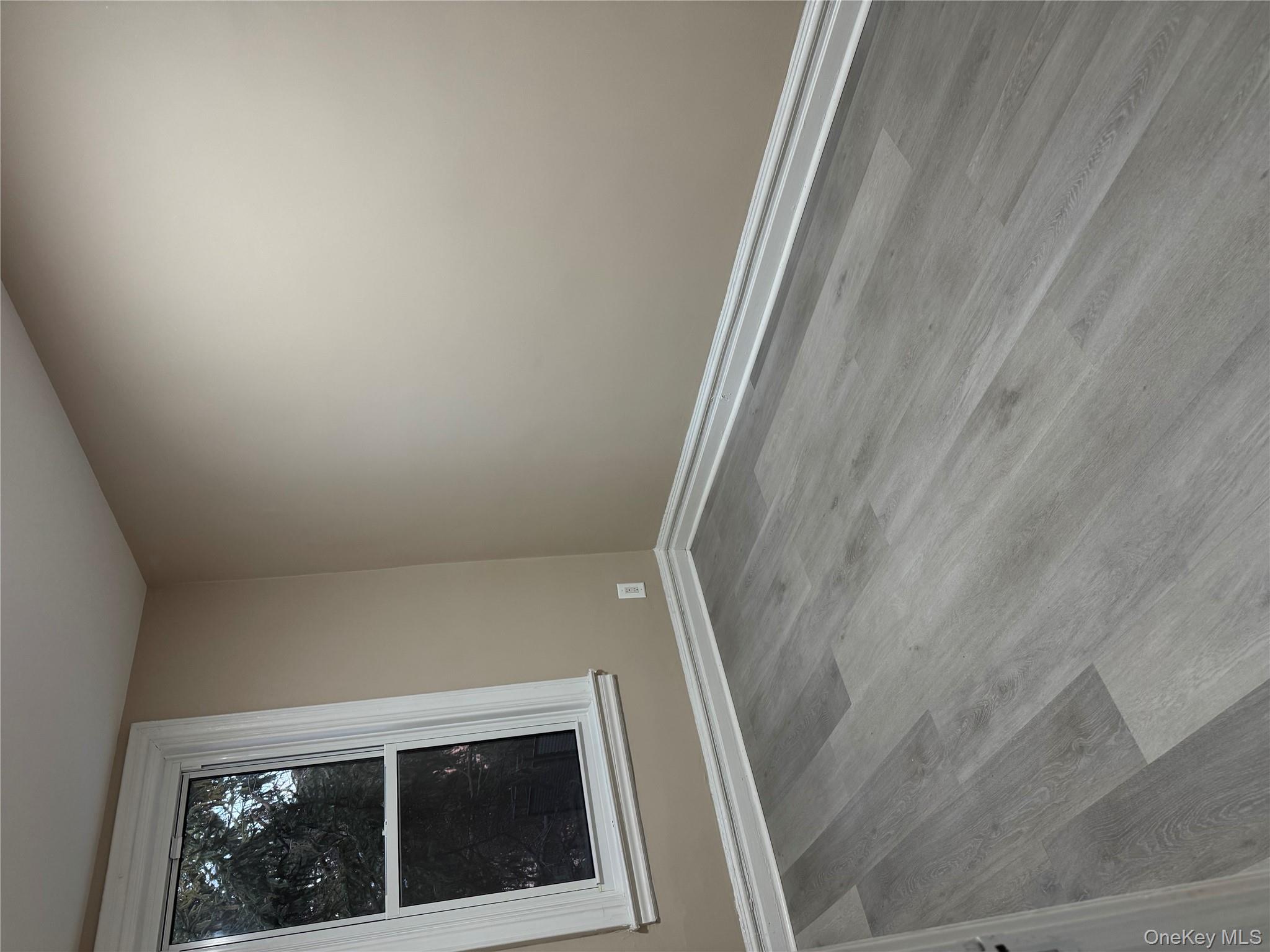 Unfurnished room featuring wood finished floors and baseboards