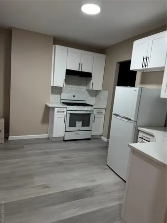 a kitchen with a refrigerator sink and stove