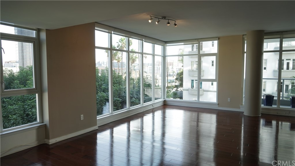 400 West Ocean Boulevard, Unit 206 Long Beach, CA 90802 - Photo 7 of 20 a view of empty room with wooden floor and windows