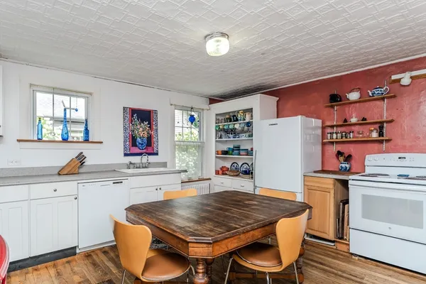 a kitchen with a table chairs stove and cabinets