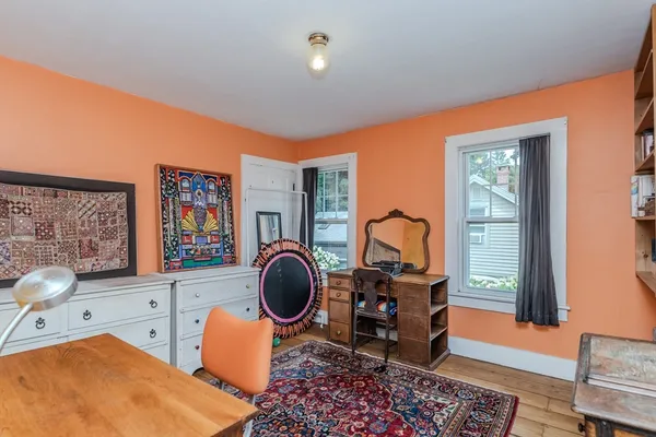 a bedroom with furniture and a window