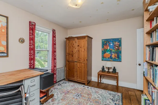 a bedroom with furniture and a chair