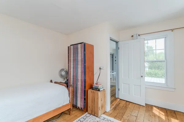 a bedroom with a bed and dresser