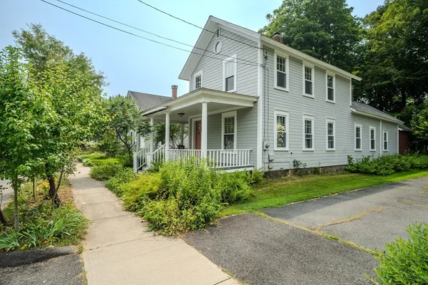 a view of a house with a yard and plants