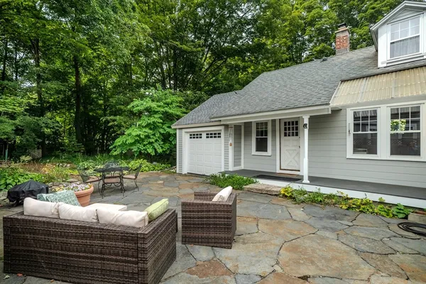 a view of a backyard with sitting area and furniture