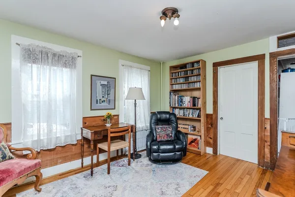 a livingroom with workspace and a window