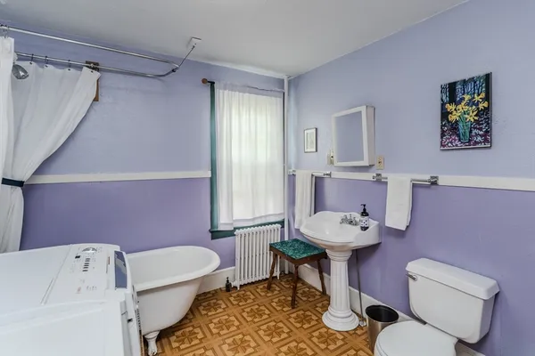 a bathroom with a sink mirror and toilet