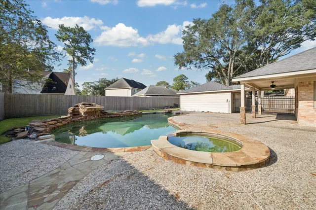 a view of a house with a backyard and a tree