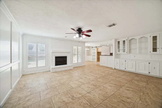a view of an empty room with a fireplace