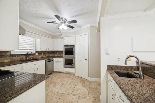 a kitchen with a stove a sink and a refrigerator