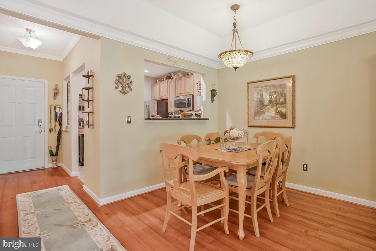 7315 Maplecrest Road, Unit 405 Elkridge, MD 21075 - Photo 12 of 76 a view of a dining room with furniture and wooden floor