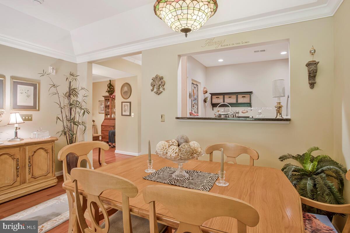 7315 Maplecrest Road, Unit 405 Elkridge, MD 21075 - Photo 13 of 76 a dining room with furniture and wooden floor