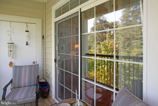 a bedroom with a bed a flat screen tv and a chandelier