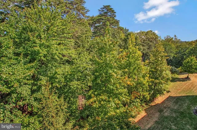 a bathroom with a granite countertop sink mirror vanity and toilet