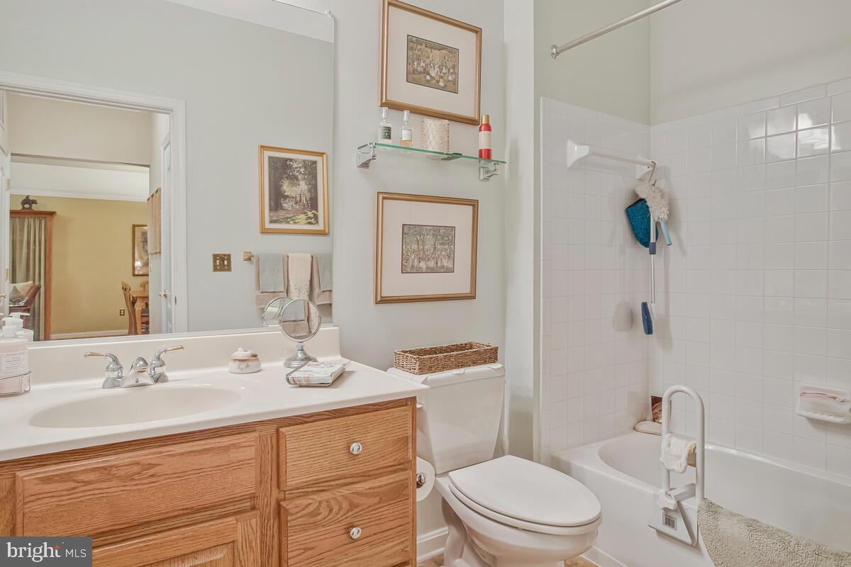 7315 Maplecrest Road, Unit 405 Elkridge, MD 21075 - Photo 29 of 76 a bathroom with a granite countertop toilet sink and mirror