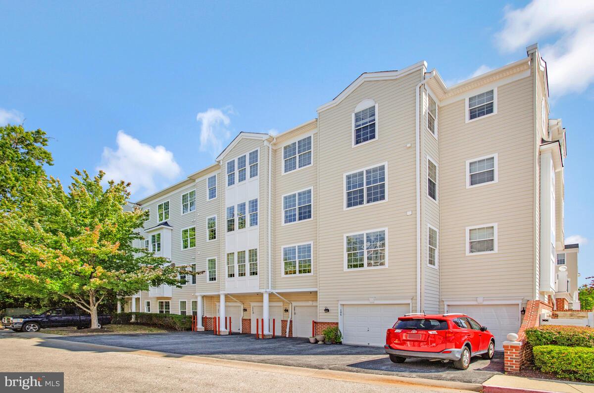 7315 Maplecrest Road, Unit 405 Elkridge, MD 21075 - Photo 38 of 76 a front view of a building with lot of cars and trees