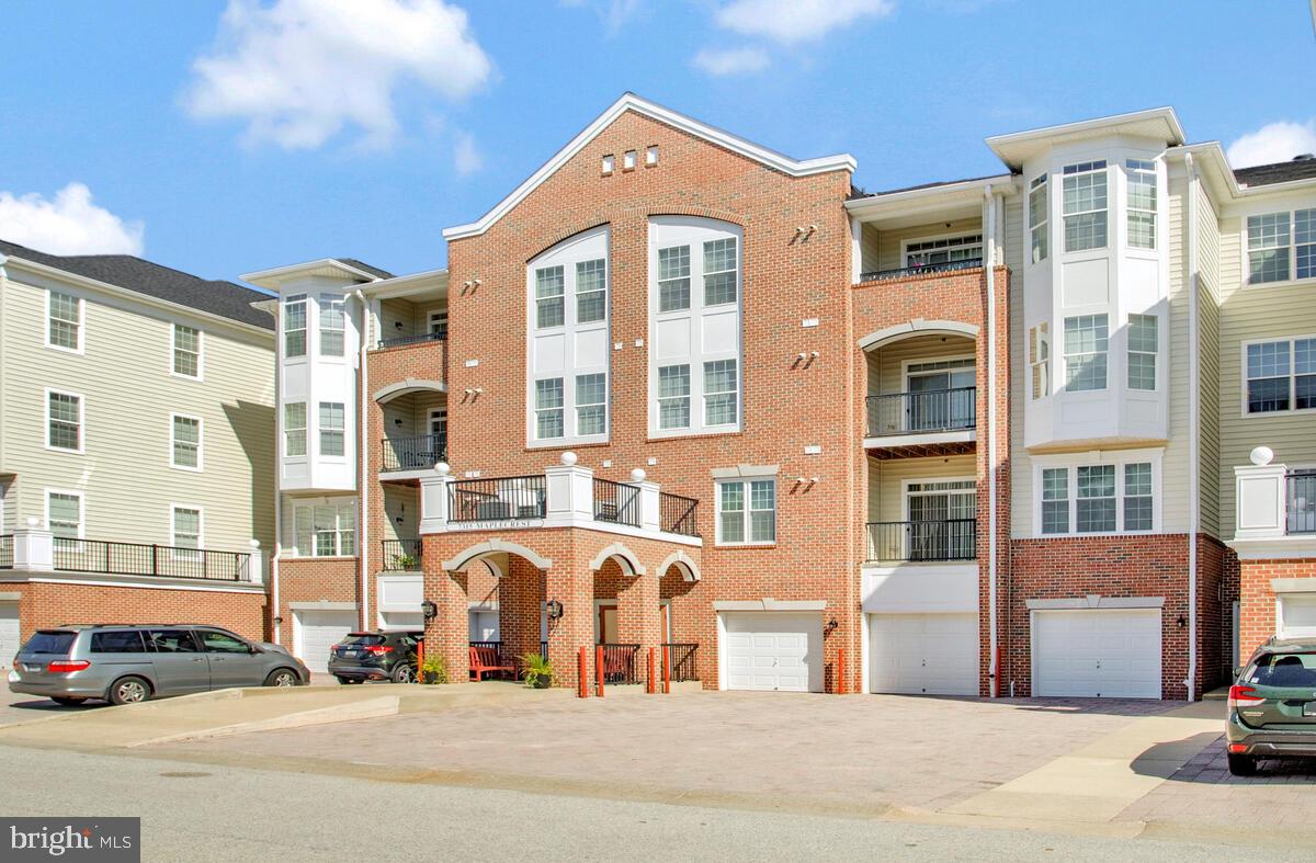 7315 Maplecrest Road, Unit 405 Elkridge, MD 21075 - Photo 39 of 76 a view of a building with cars parked on the roadside