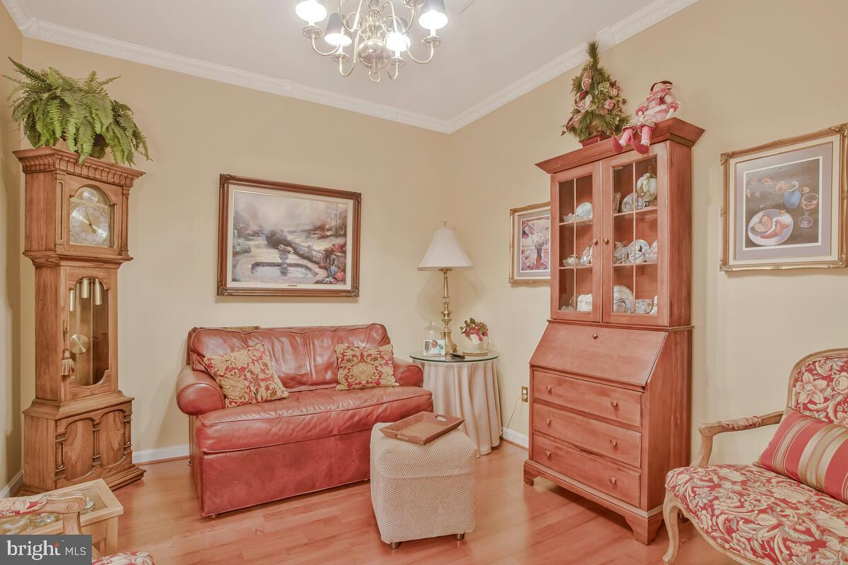 7315 Maplecrest Road, Unit 405 Elkridge, MD 21075 - Photo 5 of 76 a living room with furniture and a chandelier