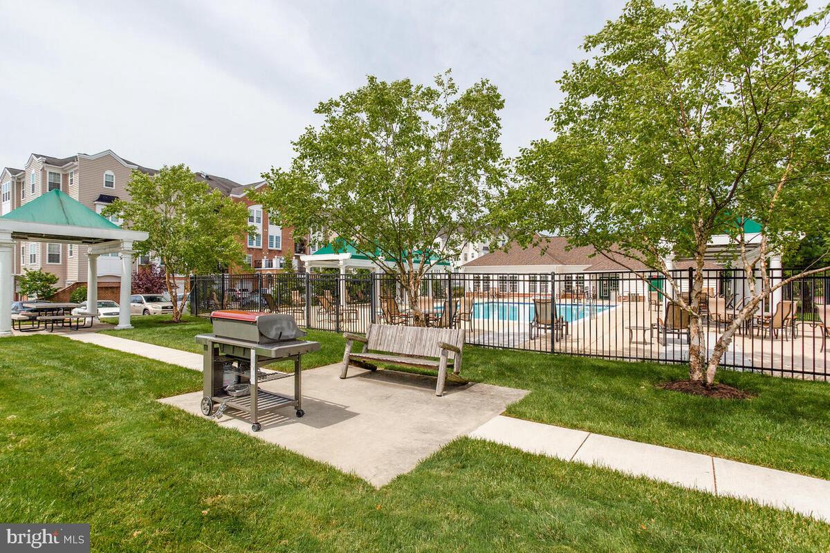 7315 Maplecrest Road, Unit 405 Elkridge, MD 21075 - Photo 68 of 76 a view of a house with backyard sitting area and garden