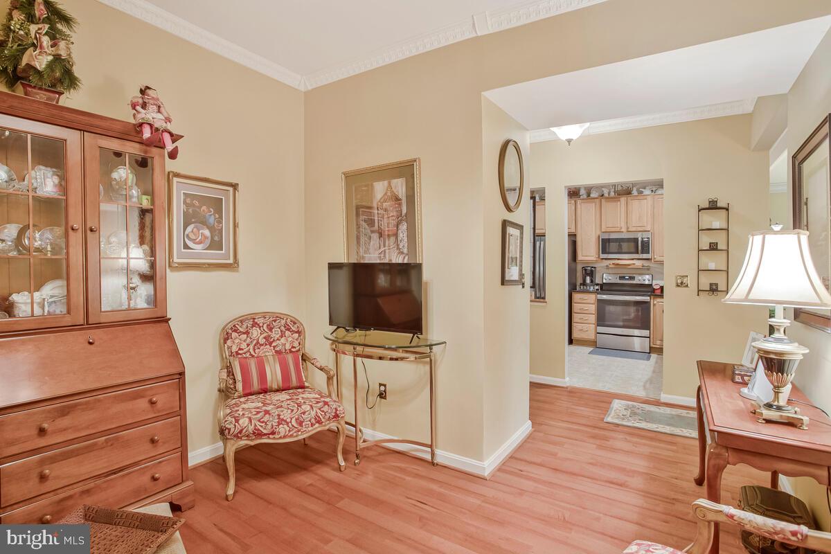 7315 Maplecrest Road, Unit 405 Elkridge, MD 21075 - Photo 6 of 76 a living room with furniture a flat screen tv and wooden floor