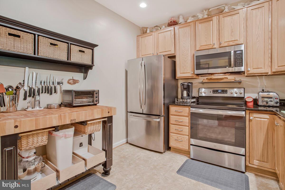 7315 Maplecrest Road, Unit 405 Elkridge, MD 21075 - Photo 7 of 76 a kitchen with stainless steel appliances a refrigerator a stove a microwave and cabinets