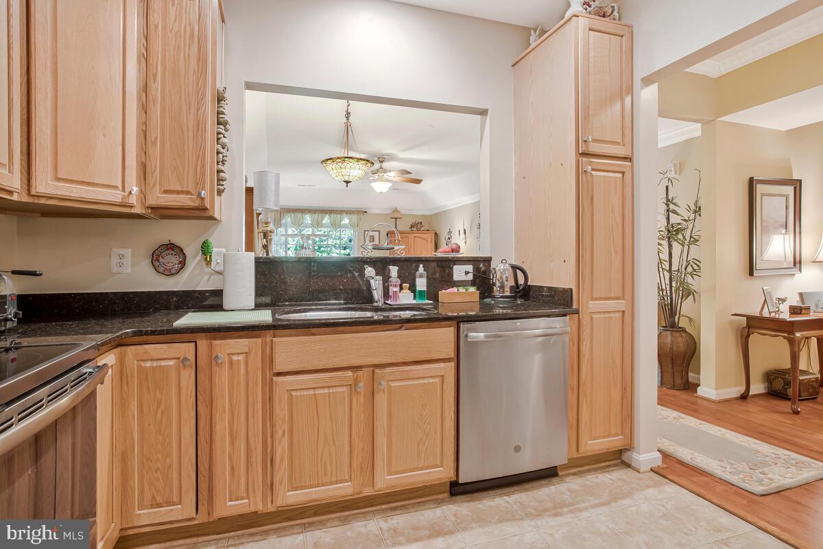 7315 Maplecrest Road, Unit 405 Elkridge, MD 21075 - Photo 9 of 76 a kitchen with granite countertop white cabinets and white appliances