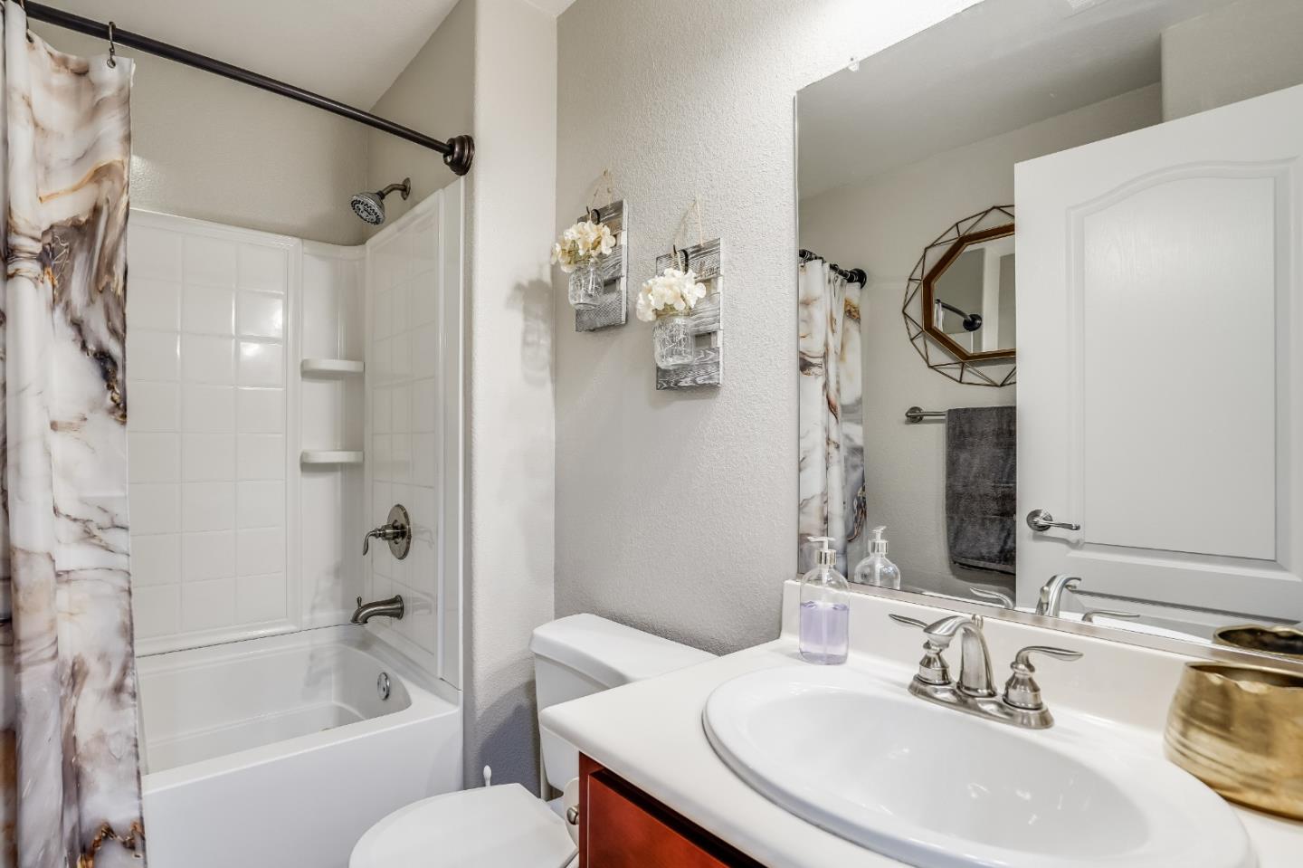 6132 Old Quarry Loop Oakland, CA 94605 - Photo 19 of 38 a bathroom with a sink vanity mirror bathtub shower and toilet