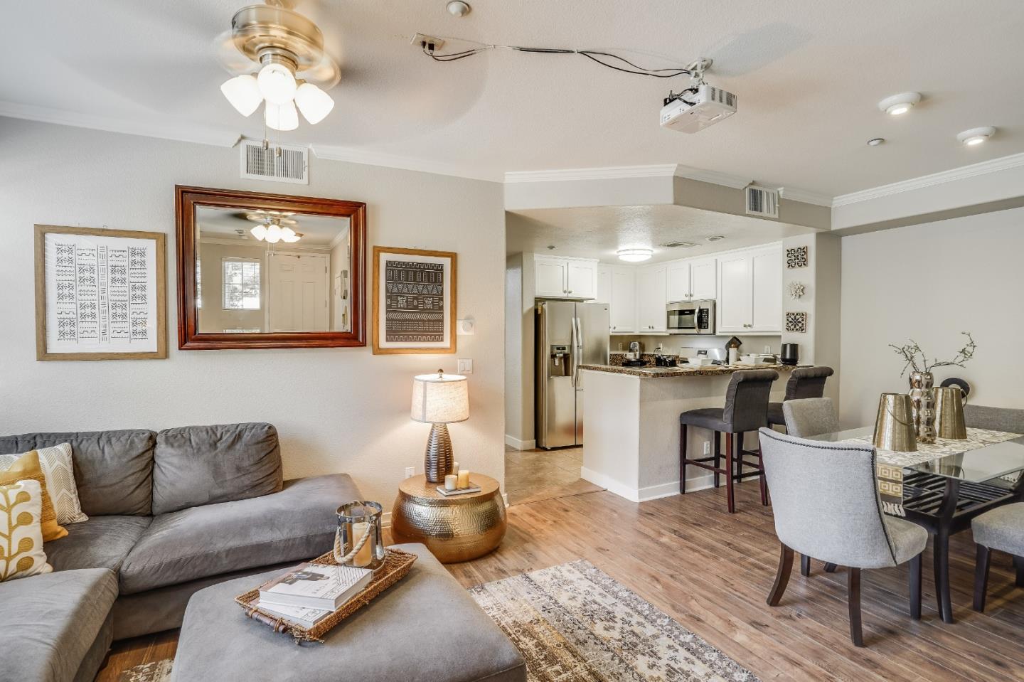 6132 Old Quarry Loop Oakland, CA 94605 - Photo 2 of 38 a living room with furniture kitchen view and a chandelier