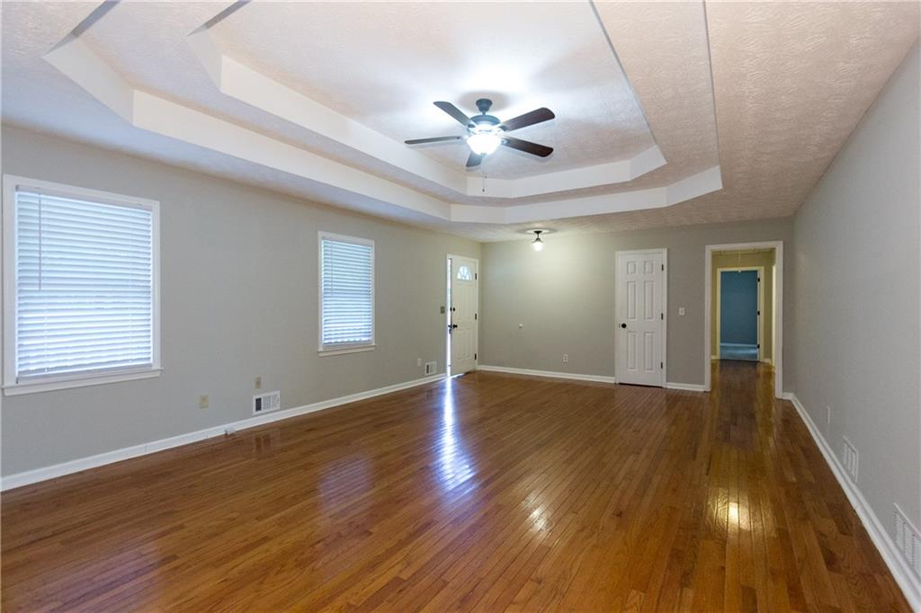 374 McGiboney Road Covington, GA 30016 - Photo 7 of 29 a view of an empty room with wooden floor and a window
