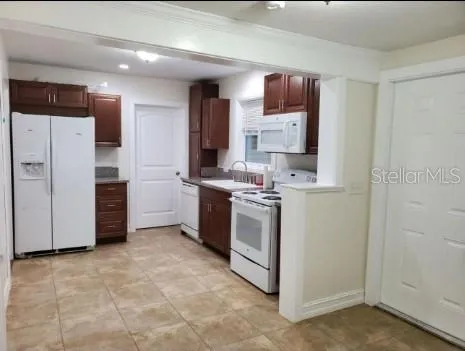 a kitchen with stainless steel appliances a stove sink and refrigerator