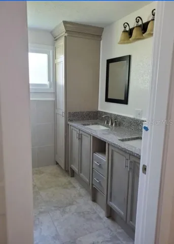 a bathroom with a sink and a mirror