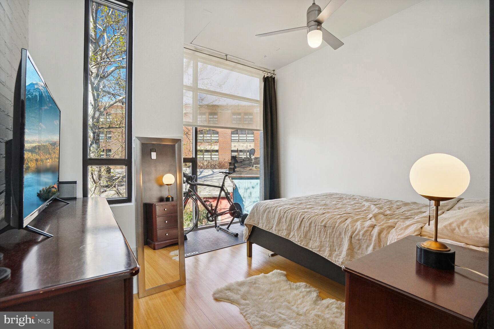 978 Florida Avenue Northwest Washington, DC 20001 - Photo 25 of 39 a bedroom with a bed and a chandelier