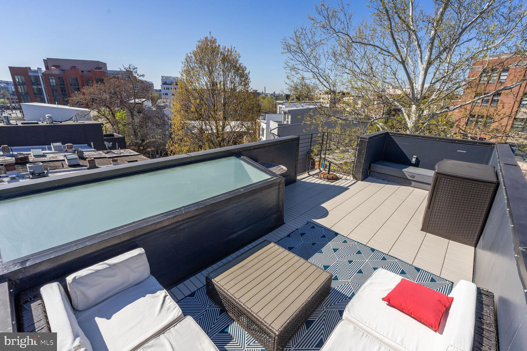 978 Florida Avenue Northwest Washington, DC 20001 - Photo 3 of 39 a view of a roof deck with couches and wooden floor
