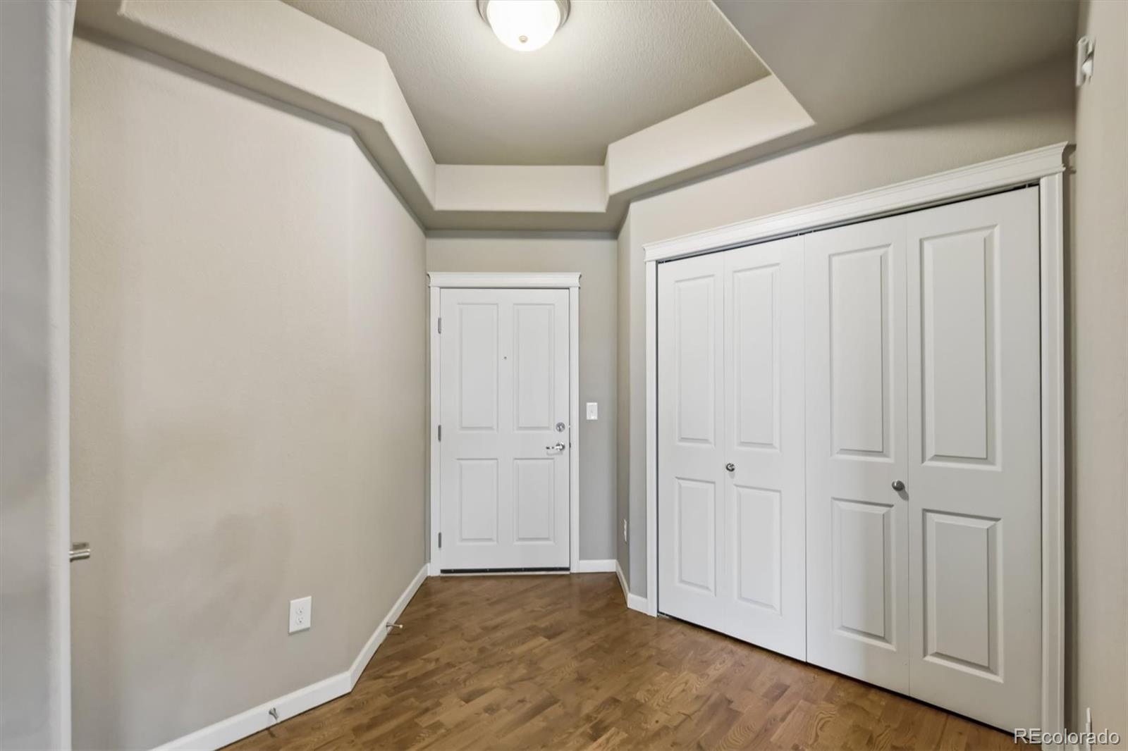 1044 Rockhurst Drive, Unit 404 Highlands Ranch, CO 80129 - Photo 11 of 28 an empty room with wooden floor