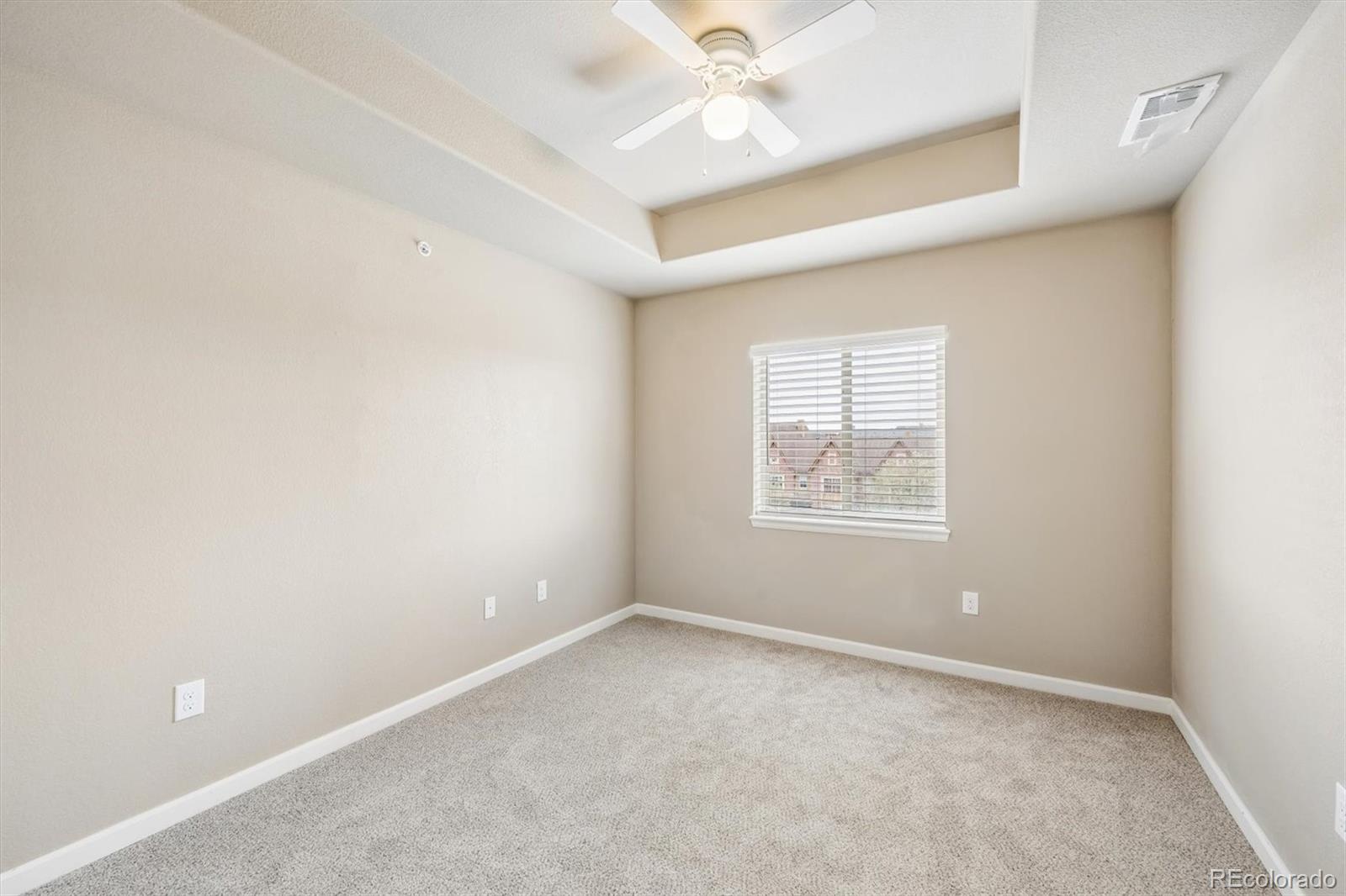 1044 Rockhurst Drive, Unit 404 Highlands Ranch, CO 80129 - Photo 18 of 28 an empty room with a window and a fan