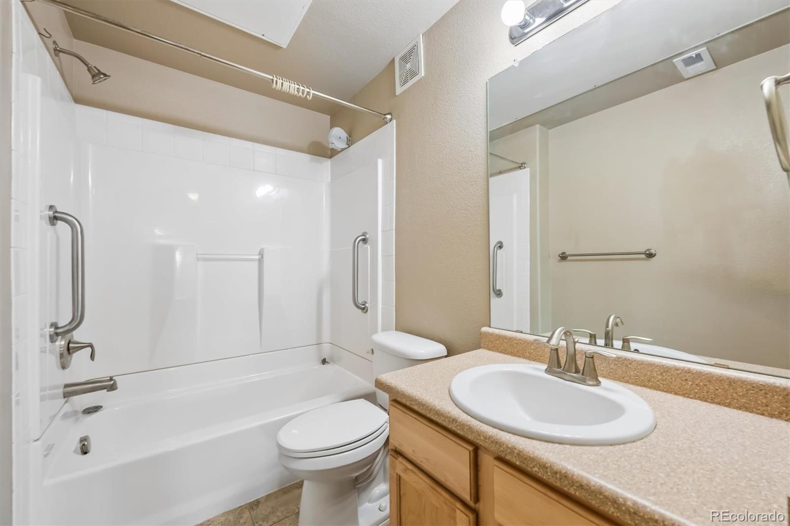 1044 Rockhurst Drive, Unit 404 Highlands Ranch, CO 80129 - Photo 20 of 28 a bathroom with a sink a toilet and shower