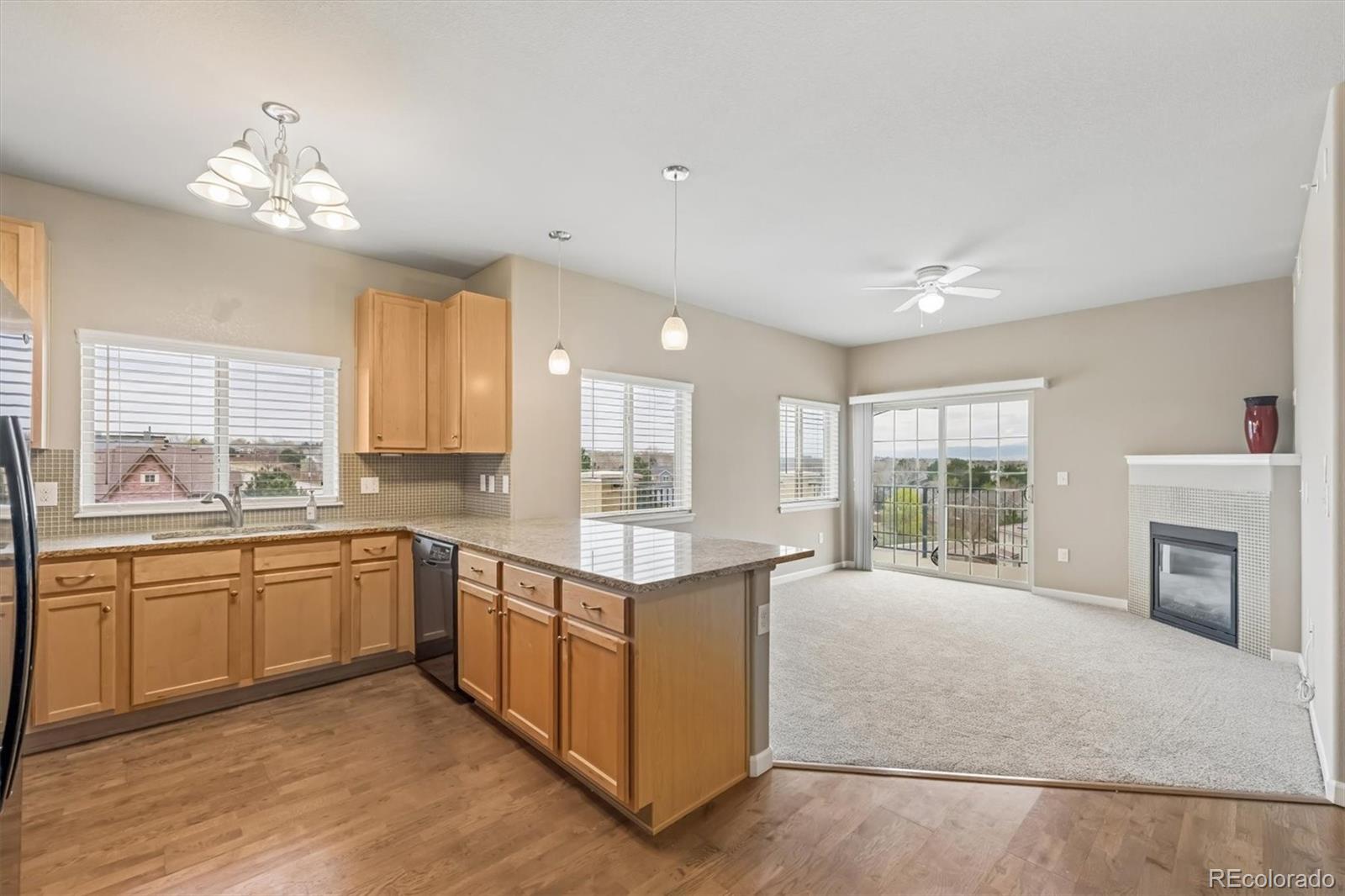 1044 Rockhurst Drive, Unit 404 Highlands Ranch, CO 80129 - Photo 2 of 28 a large kitchen with a large window and stainless steel appliances