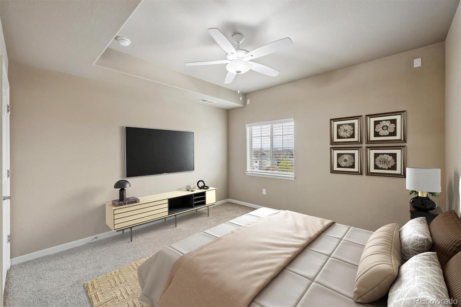 1044 Rockhurst Drive, Unit 404 Highlands Ranch, CO 80129 - Photo 6 of 28 a bedroom with a bed and a flat screen tv