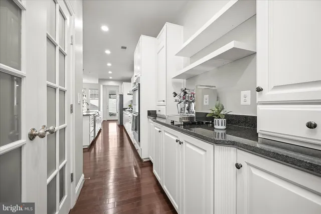 a view of a kitchen with cabinets and wooden floor