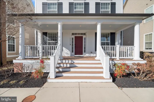 a view of a house with a small yard and wooden floor and fence