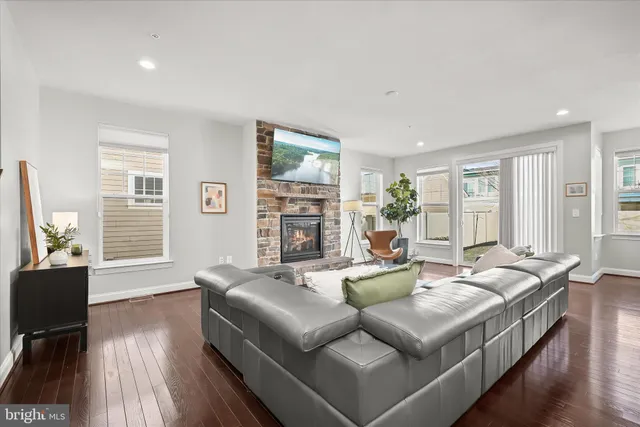 a living room with fireplace furniture and a wooden floor