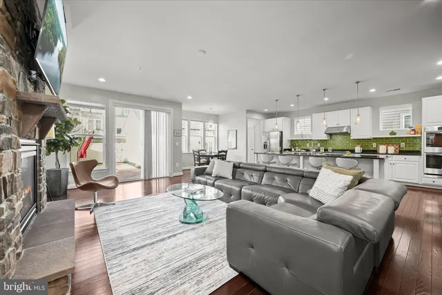 a living room with lots of furniture and kitchen view