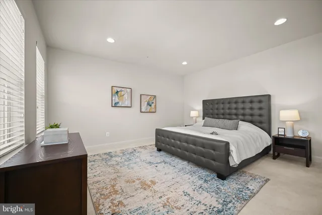 a spacious bedroom with a bed and a window