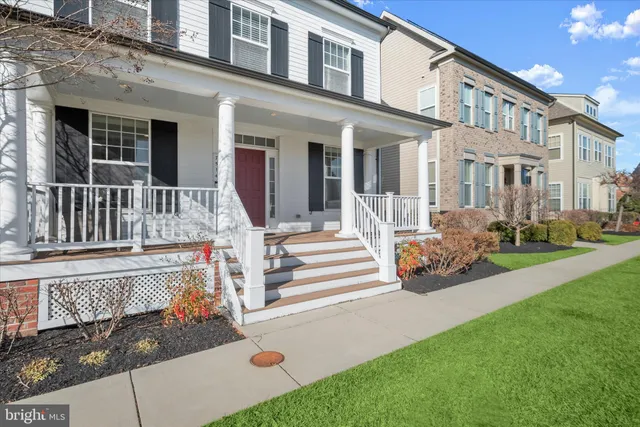 a view of a house with a small yard and wooden fence